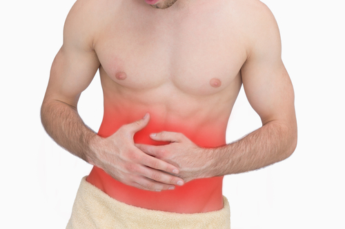 Midsection of man with stomach ache over white background