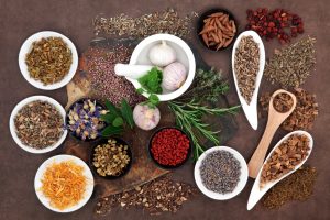 various healing herbs on a wooden table